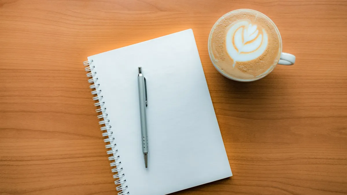 Notebook and pen beside a coffee
